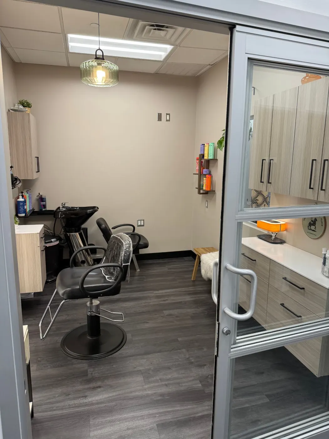 Open suite door showing the styling chair and shampoo station
