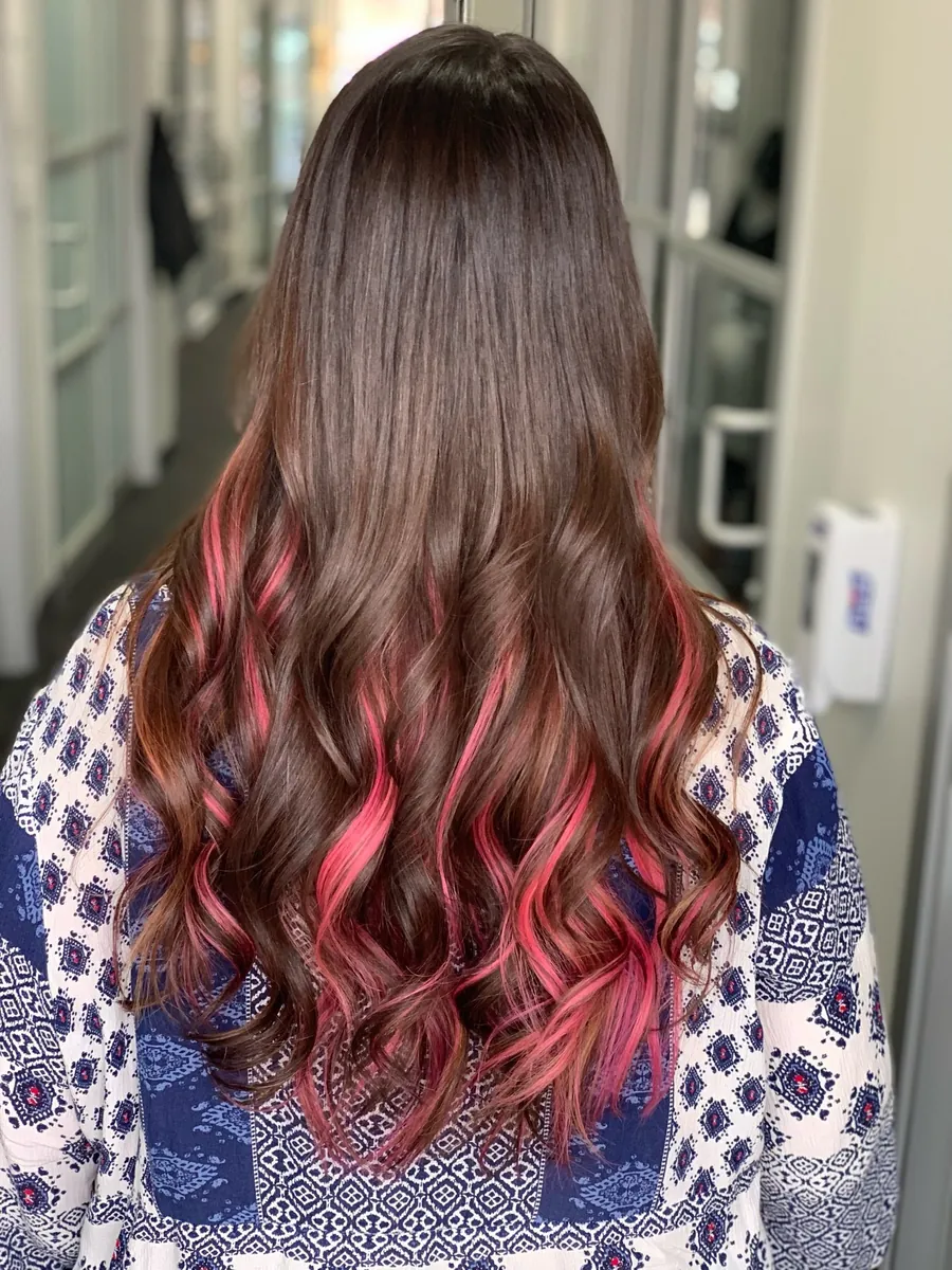 Long brunette hair with pink-red peekaboo color